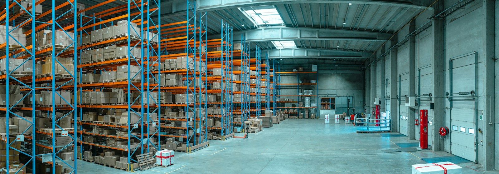 Tall racking stocked with boxed industrial supplies in a distributor's warehouse